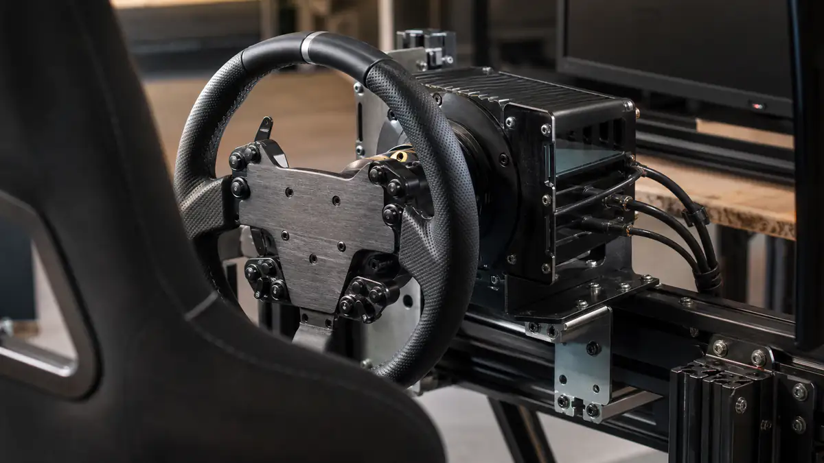 Direct-drive wheelbase and steering wheel mounted to an aluminum-profile racing cockpit
